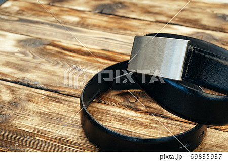 Fashionable male belt on brown wooden background 69835937