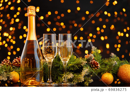 Champagne bottle and glasses on blurred lights background Champagne bottle and glasses on blurred lights background 69836275