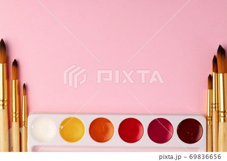 Watercolor paint with set of brushes on pink background Watercolor paint with set of brushes on pink background 69836656
