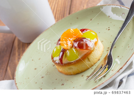 Tart with fruits topping on green plate 69837463