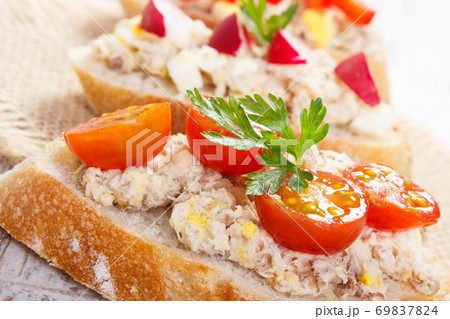 Closeup of crusty baguette with mackerel or tuna fish paste, healthy nutrition Closeup of crusty baguette with mackerel or tuna fish paste, healthy nutrition 69837824