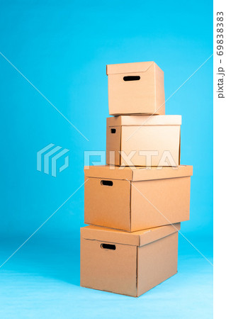 Stack of cardboard boxes on blue background 69838383