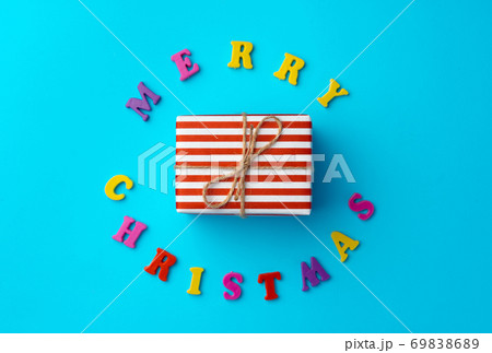 Words Merry Christmas on blue background top view Words Merry Christmas on blue background top view 69838689