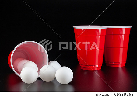 Red plastic cups and ball for game of beer pong 69839568