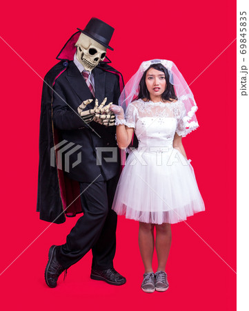 Grim Reaper holds hand of bride 69845835