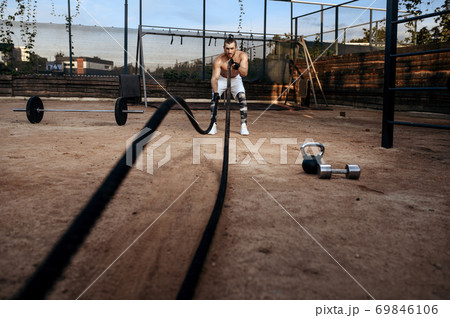 Man doing exercise with ropes, workout, crossfit 69846106