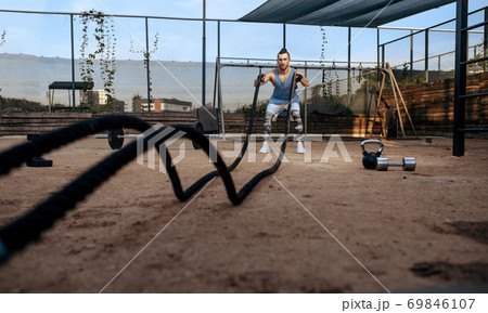 Man doing exercise with ropes, workout, crossfit Man doing exercise with ropes, workout, crossfit 69846107