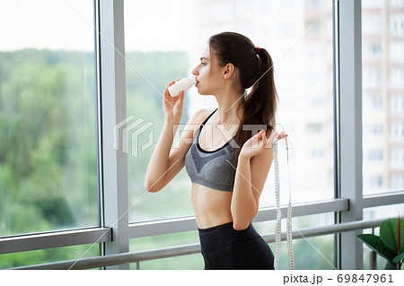 Close-up portrait of an attractive young woman drink yogurt Close-up portrait of an attractive young woman drink yogurt 69847961