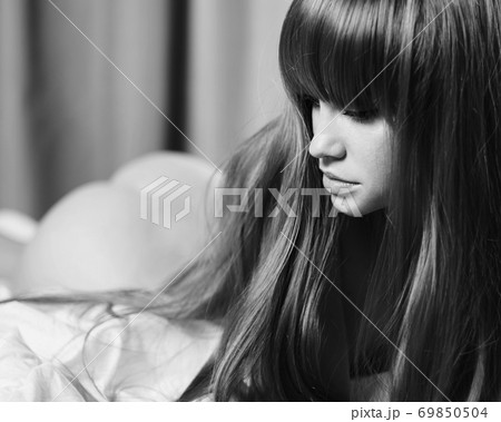 Fashion portrait of young sensual woman in bed. Redhead lady in bedroom. 69850504