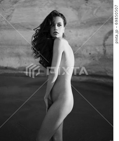 Beautiful brunette woman on the beach Beautiful brunette woman on the beach 69850507