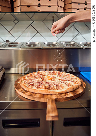 Man adding ingredients on dough 69851806