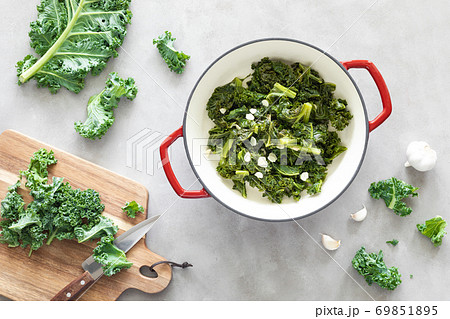 Sauteed kale with garlic in cast iron pan on kitchen table, healthy food concept, superfood 69851895
