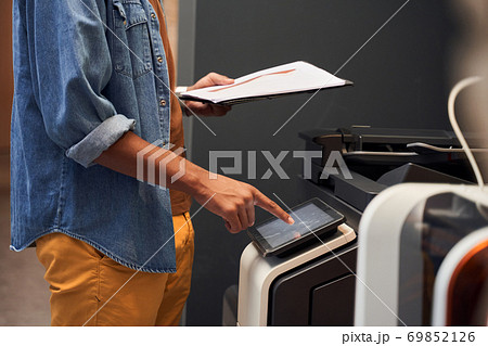 Man making copies and working with printer 69852126