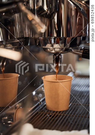 Cardboard cup standing on the grating 69852436