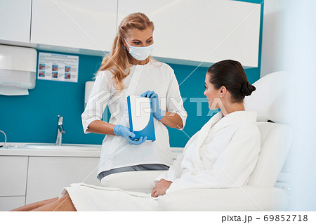 Doctor showing injection box to her patient 69852718