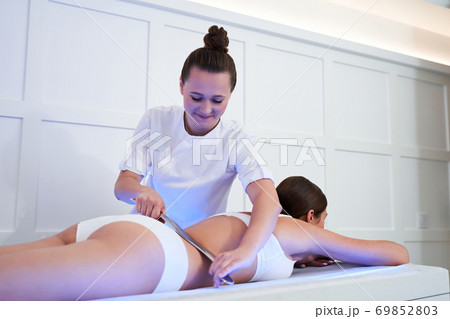 Woman having procedure of massage Woman having procedure of massage 69852803