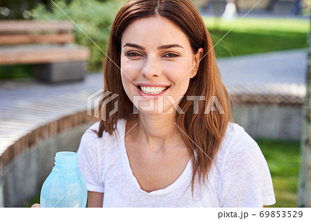 Woman with bottle of fresh water 69853529