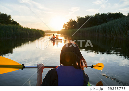 Group of happy tourists walking on kayaks 69853773
