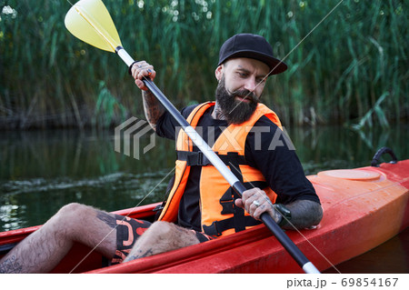 Waist up portrait of tattooed guy in kayak 69854167