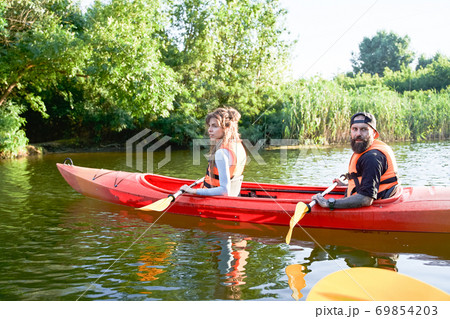 Young couple kayaking on river Young couple kayaking on river 69854203