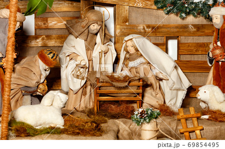 Puppet composition of the Nativity of Christ with the Jesus, Virgin Mary, Joseph, a manger, straw and the Magi who came. 69854495