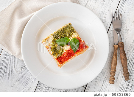 Portion of lasagne on white plate Portion of lasagne on white plate 69855869