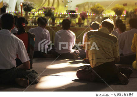 Burmese man chanting in Nga Htat Gyi Pagoda in Myanmar. 69856394