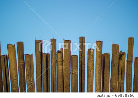 Wicker roof beach umbrella and blue sky. Natural bamboo sunshades and summer umbrella parasol on blue sea shore. 69858866