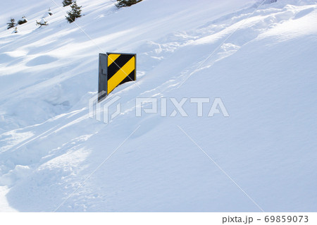 Country road sign after heavy snowfall on sunny day Country road sign after heavy snowfall on sunny day 69859073