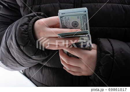 Hands holding cash USD dollar banknotes. Currency, Cash, Bill Hands holding cash USD dollar banknotes. Currency, Cash, Bill 69861017