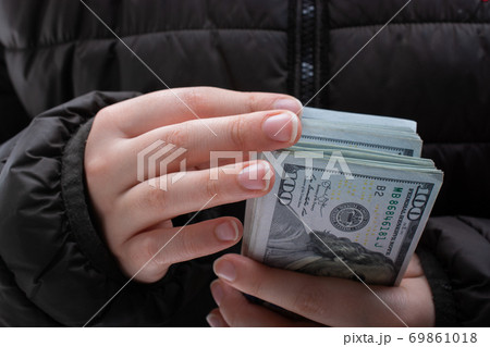 Hands holding cash USD dollar banknotes. Currency, Cash, Bill Concept Hands holding cash USD dollar banknotes. Currency, Cash, Bill Concept 69861018