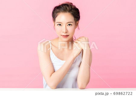 Beautiful young asian woman with clean fresh skin on pink background, Face care, Facial treatment, 69862722