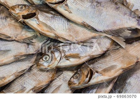 Dried fish background. Salty dry river fish top view with copy space 69863070