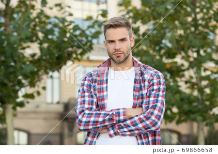 Good looking guy stand outdoors with crossed arms Good looking guy stand outdoors with crossed arms 69866658