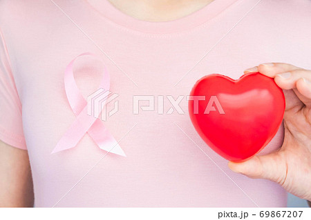 World Breast Cancer Day Concept,health care - woman wore pink t-shirt with Pink ribbon for awareness, symbolic bow color raising on people living with women's breast tumor illness 69867207
