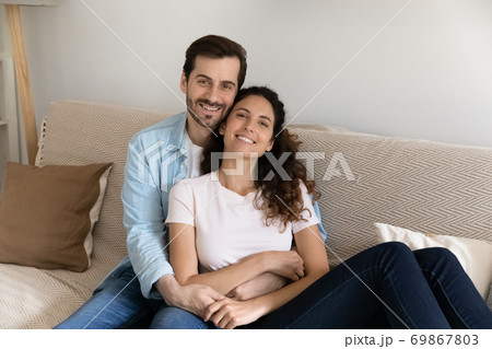 Portrait of happy couple renters relax on couch 69867803
