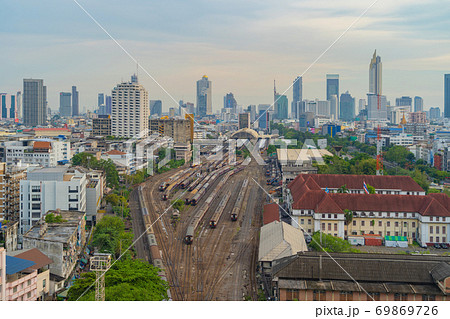 Aerial view of Thai local old classic train or tram on railway in Hua Lamphong terminal station with skyscraper buildings in urban city, Bangkok town, Thailand in public transportation concept. Aerial view of Thai local old classic train or tram on railway in Hua Lamphong terminal station with skyscraper buildings in urban city, Bangkok town, Thailand in public transportation concept. 69869726