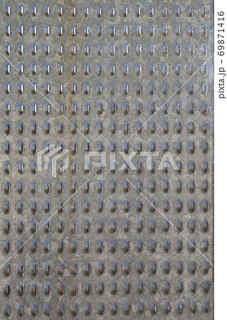Vertical image of a sheet of perforated metal. Vertical image of a sheet of perforated metal. 69871416
