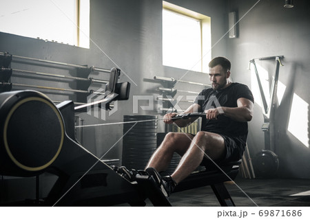 Strong Man Has Active Training On Fitness Equipment . Strong Man Has Active Training On Fitness Equipment . 69871686