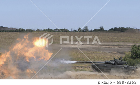 The tank fires a cannon and jumps from a springboard at the training ground The tank fires a cannon and jumps from a springboard at the training ground 69873265