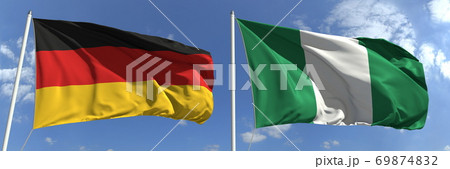Flying flags of Germany and Nigeria on sky background, 3d rendering Flying flags of Germany and Nigeria on sky background, 3d rendering 69874832
