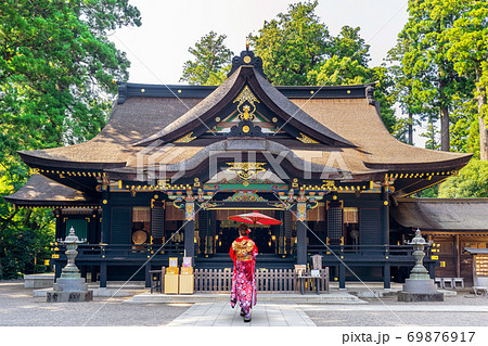 Woman wearing japanese traditional kimono with umbrella at katori shrine in Chiba, Japan. Woman wearing japanese traditional kimono with umbrella at katori shrine in Chiba, Japan. 69876917