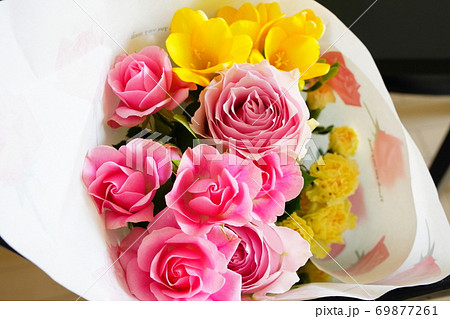 ピンクのバラと黄色いスイートピーの花束の写真素材