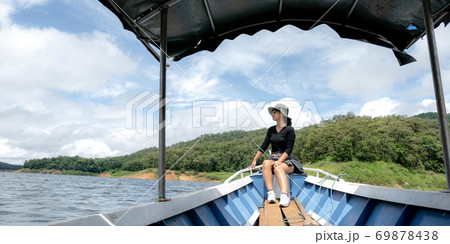 Tourist Asian young woman sitting on boat travel as dream lifestyle people happy luxury trip in vacation 69878438