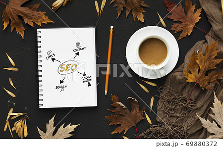 Opened Notebook With Seo Scheme Lying On Black Desk Background Opened Notebook With Seo Scheme Lying On Black Desk Background 69880372