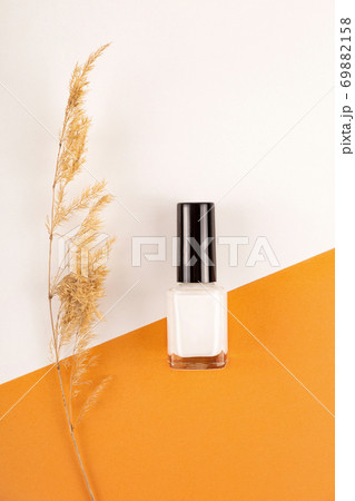 Vegan nude nail polish on natural background with dry spikelets Vegan nude nail polish on natural background with dry spikelets 69882158