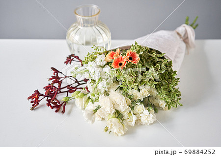 Bouquet 003. Sekective focus on flowers. Series, step by step installation of flowers in a vase. Flowers bunch, set for home. Delivery fresh cut flower. 69884252
