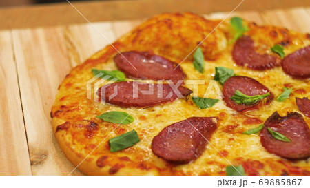 Appetizing hot pepperoni pizza lies on a tray. Appetizing hot pepperoni pizza lies on a tray. Close Appetizing hot pepperoni pizza lies on a tray. Appetizing hot pepperoni pizza lies on a tray. Close 69885867