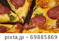 Human hands taking pieces slices of hot tasty italian pizza from open box, close up view 69885869