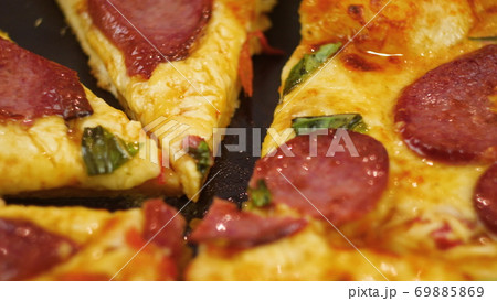 Human hands taking pieces slices of hot tasty italian pizza from open box, close up view 69885869
